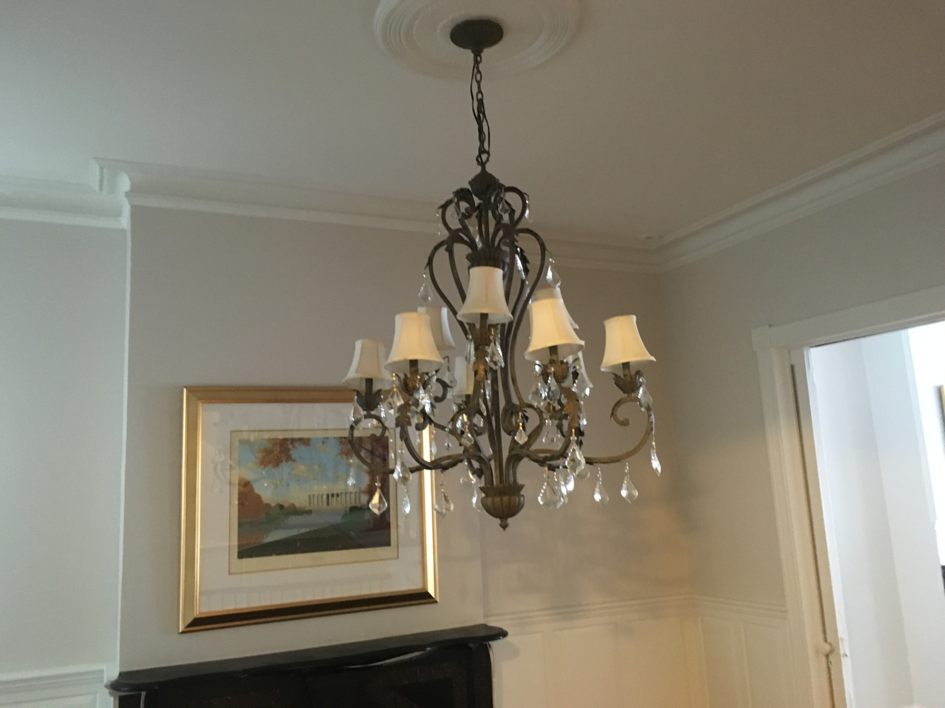 Crystal chandelier hung and wired in a dining room