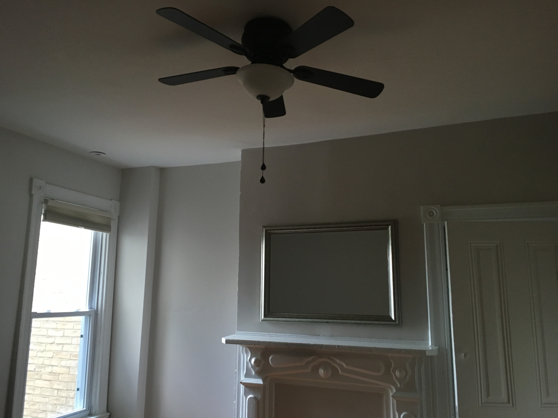 Ceiling fan with light kit installed in a bedroom
